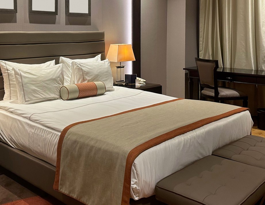 Made hotel bed with folded throw