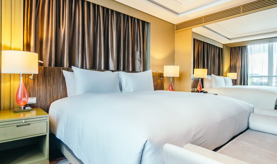 Hotel suite with a made bed