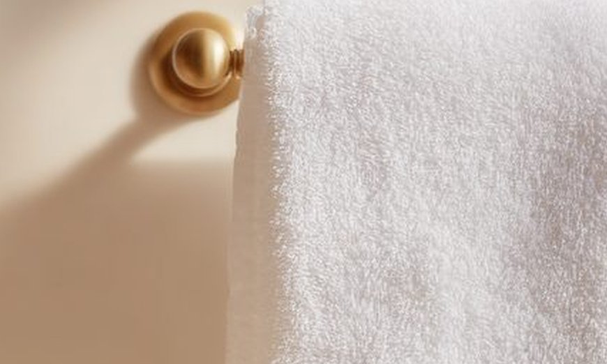 Soft white towel on a brass rail